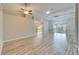 Bright, open living space with wood-look tile, ceiling fan, and sliding glass doors at 2222 Mayfield Palms Ln # 322, Sun City Center, FL 33573
