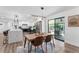 Dining area featuring modern lighting fixture and sliding glass doors to outdoor living space at 2297 Demaret Dr, Dunedin, FL 34698