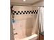 Clean bathroom featuring a tub and shower with black and white accents at 2320 W Azeele St # 317, Tampa, FL 33609