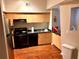 Well-lit kitchen boasts wood floors and black appliances at 2320 W Azeele St # 317, Tampa, FL 33609