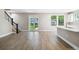 Open living space with wood-look tile flooring, staircase, and French doors leading to the backyard at 2618 15Th N Ave, St Petersburg, FL 33713