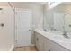 Bathroom showcasing a shower with white tiles, double sinks, white countertops, and modern fixtures at 37233 Sagemoor Dr, Zephyrhills, FL 33541