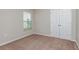 Bedroom featuring a large closet and a window that fills the room with natural light and a cozy carpet at 37233 Sagemoor Dr, Zephyrhills, FL 33541