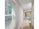 Hallway features modern vinyl flooring, neutral-colored walls and the kitchen at the end of the hallway at 37233 Sagemoor Dr, Zephyrhills, FL 33541