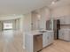 Kitchen island featuring stainless steel dishwasher and sink, opening to the living space at 37233 Sagemoor Dr, Zephyrhills, FL 33541