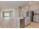 Modern kitchen featuring stainless steel appliances and gray cabinets plus an island with white countertop at 37233 Sagemoor Dr, Zephyrhills, FL 33541