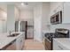 Open kitchen featuring stainless steel appliances, light gray cabinetry, and eat-in counter at 37233 Sagemoor Dr, Zephyrhills, FL 33541