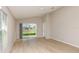 Living room featuring wood flooring, neutral walls, and sliding glass door to the backyard at 37233 Sagemoor Dr, Zephyrhills, FL 33541