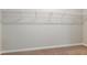 Walk-in closet with metal shelving, baseboards and neutral colored walls and carpeted floors at 37233 Sagemoor Dr, Zephyrhills, FL 33541