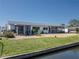 Waterfront home with a spacious backyard, gravel and enclosed porch at 3729 Sail Dr, New Port Richey, FL 34652
