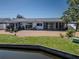 Backyard of waterfront home featuring gravel, grass and enclosed porch at 3729 Sail Dr, New Port Richey, FL 34652