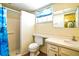 Bathroom featuring a step-in shower, updated vanity and linoleum flooring, and blue accents at 3729 Sail Dr, New Port Richey, FL 34652