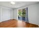 Bedroom featuring wood floors, sliding glass door leading to patio, and closet at 3729 Sail Dr, New Port Richey, FL 34652