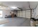 Unfinished garage with overhead lighting, utility sink, and space for storage at 3729 Sail Dr, New Port Richey, FL 34652