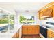 Kitchen featuring granite countertops, wood cabinets, stainless steel sink, and water view at 3729 Sail Dr, New Port Richey, FL 34652