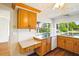 Kitchen features granite countertops, wood cabinets, modern appliances, and scenic pond views at 3729 Sail Dr, New Port Richey, FL 34652