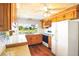 Kitchen featuring wood cabinets, granite counters, white appliances, and a scenic water view at 3729 Sail Dr, New Port Richey, FL 34652
