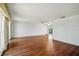 Living room featuring wood floors, white walls, wainscotting, and glass doors that offer backyard views at 3729 Sail Dr, New Port Richey, FL 34652