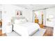 Bright main bedroom with a neutral palette features wood floors, a ceiling fan, and access to the ensuite bath at 3729 Sail Dr, New Port Richey, FL 34652