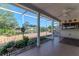 Covered patio with scenic views of a serene pond and landscaped backyard creating a peaceful outdoor retreat at 3729 Sail Dr, New Port Richey, FL 34652