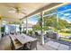 Covered outdoor patio boasts ample seating, grill, and an idyllic view of lush greenery and a peaceful pond setting at 3729 Sail Dr, New Port Richey, FL 34652