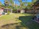 Expansive backyard featuring a shed and screened patio perfect for outdoor living and storage at 402 8Th Sw St, Ruskin, FL 33570