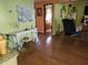 Cozy living room featuring wood-look floors and a view into the bathroom at 402 8Th Sw St, Ruskin, FL 33570