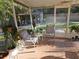 Relaxing screened patio area showcasing comfortable seating, tiled floor and backyard view at 402 8Th Sw St, Ruskin, FL 33570