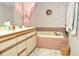 Bathroom featuring a built-in tub, double sink vanity, and neutral color scheme at 4078 Salem Square Pkwy, Palm Harbor, FL 34685