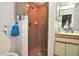Tiled bathroom showcasing a glass-enclosed shower, single sink vanity, and pink color scheme at 4078 Salem Square Pkwy, Palm Harbor, FL 34685