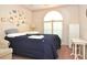 Comfortable bedroom with natural light from a window fitted with shutters at 4078 Salem Square Pkwy, Palm Harbor, FL 34685