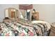 Comfortable bedroom featuring a large bed with floral bedding, neutral walls, and natural light at 4078 Salem Square Pkwy, Palm Harbor, FL 34685
