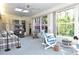 Sunny bonus room featuring a skylight, fans and exterior views through large windows at 4078 Salem Square Pkwy, Palm Harbor, FL 34685