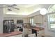 Bright kitchen with stainless steel refrigerator, white cabinetry, and stainless steel appliances under a skylight at 4078 Salem Square Pkwy, Palm Harbor, FL 34685