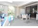Bright living area featuring a sliding glass door to the outside and comfortable seating at 4078 Salem Square Pkwy, Palm Harbor, FL 34685