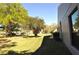 Exterior featuring side yard, mature trees and green space offering a serene and private outdoor area at 4078 Salem Square Pkwy, Palm Harbor, FL 34685