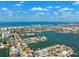 Panoramic aerial view of a coastal city, showing ocean, bay, and residential waterfront properties at 6410 3Rd Palm Pt, St Pete Beach, FL 33706