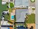 A bird's eye view featuring a roof, pool, tropical foliage, and a boat dock at 6410 3Rd Palm Pt, St Pete Beach, FL 33706