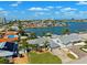 An aerial view featuring waterfront homes with docks, lush lawns, and mature trees at 6410 3Rd Palm Pt, St Pete Beach, FL 33706