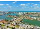 An aerial shot shows waterfront homes with boat docks in a charming community at 6410 3Rd Palm Pt, St Pete Beach, FL 33706