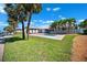 Charming backyard with a pool, gazebo, lush lawn, and views of the waterfront and boat dock at 6410 3Rd Palm Pt, St Pete Beach, FL 33706