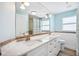 Bright, spacious bathroom featuring a double sink vanity, shower with tiled walls and floors, and ample counter space at 6410 3Rd Palm Pt, St Pete Beach, FL 33706
