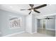 Bedroom featuring stylish ceiling fan, closet, and window with bright natural light at 6410 3Rd Palm Pt, St Pete Beach, FL 33706