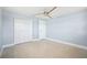Bright bedroom with terrazzo floors, ceiling fan, a double closet, and fresh light blue paint at 6410 3Rd Palm Pt, St Pete Beach, FL 33706