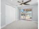 Bedroom featuring stylish ceiling fan and sliding glass doors with a waterfront view at 6410 3Rd Palm Pt, St Pete Beach, FL 33706
