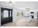 Open floor plan with dark double door entryway and a view into the kitchen with an island at 6410 3Rd Palm Pt, St Pete Beach, FL 33706