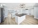 Bright, open kitchen with a large island, pendant lights, and stainless steel appliances at 6410 3Rd Palm Pt, St Pete Beach, FL 33706