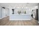 Modern kitchen with white cabinets, a large center island, and stainless steel appliances at 6410 3Rd Palm Pt, St Pete Beach, FL 33706