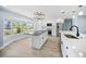 Spacious kitchen with black and stainless appliances, a bay window, and a large kitchen island at 6410 3Rd Palm Pt, St Pete Beach, FL 33706