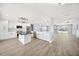 Bright kitchen features white cabinetry, stainless steel appliances, a large island, and modern lighting at 6410 3Rd Palm Pt, St Pete Beach, FL 33706